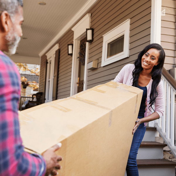 Couple Carrying Big Box Purchase Into House