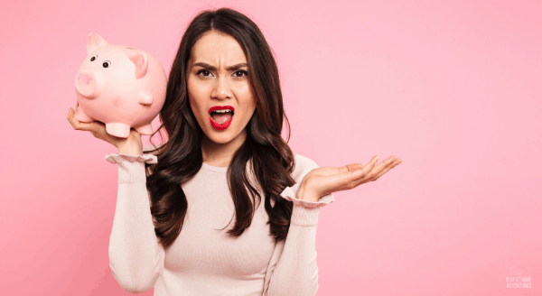 women holding a piggy bank