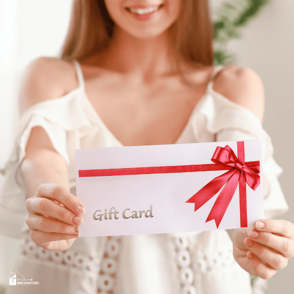 pretty girl with a gift card at home