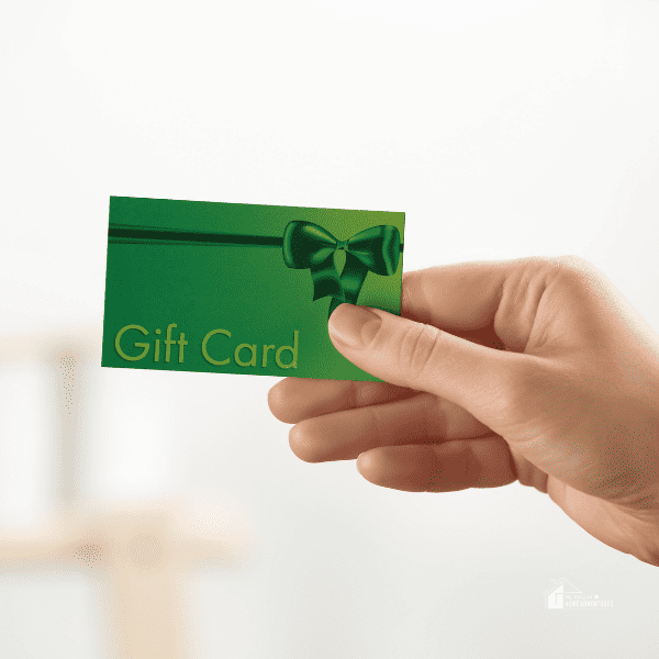 Woman Holding Gift Card on Blurred Background, Closeup