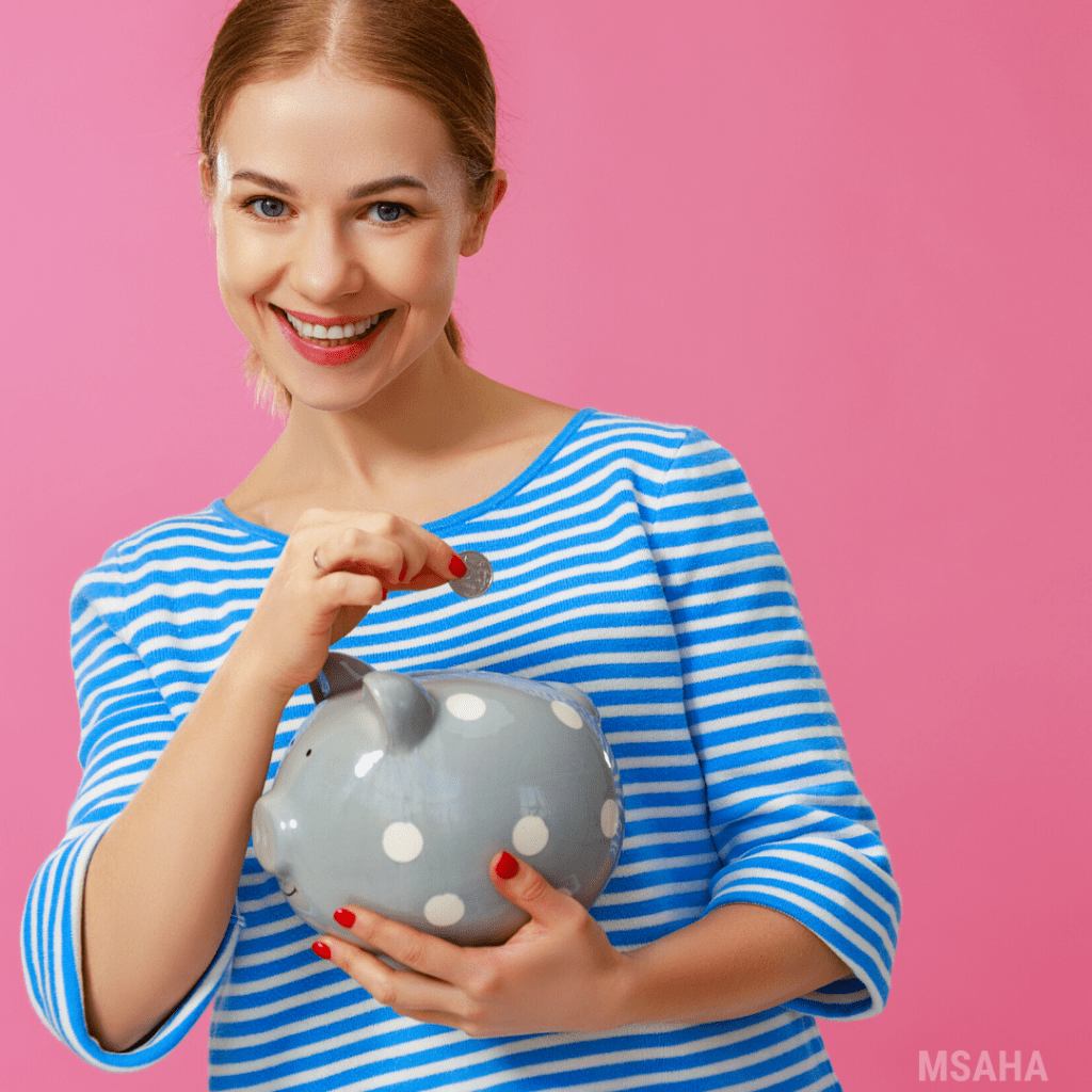 woman putting a quarter inside a gray color piggy bank.