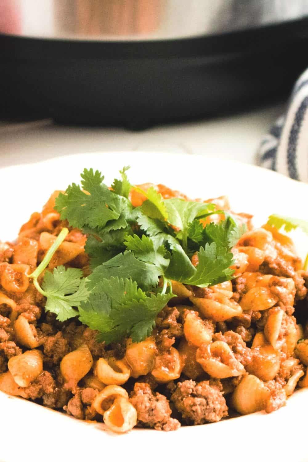 Learn to create this Instant Pot Puerto Rican Cheesy Taco Pasta recipe your family is going to love. Super simple to make and super cheesy! via @mystayathome