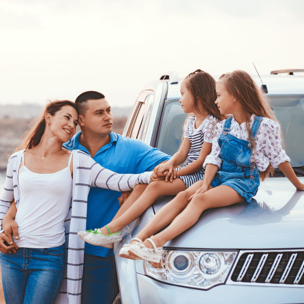 Family trip by car the sea shore in sunset.