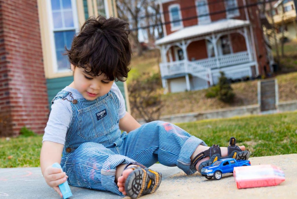 Alex playing with sidewalk chalk