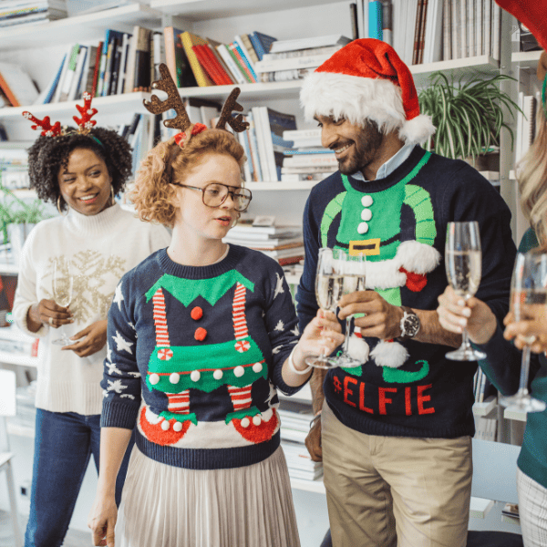 People wearing ugly swearter in a Christmas party.