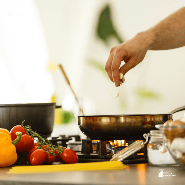 someone cooking in a gas stove