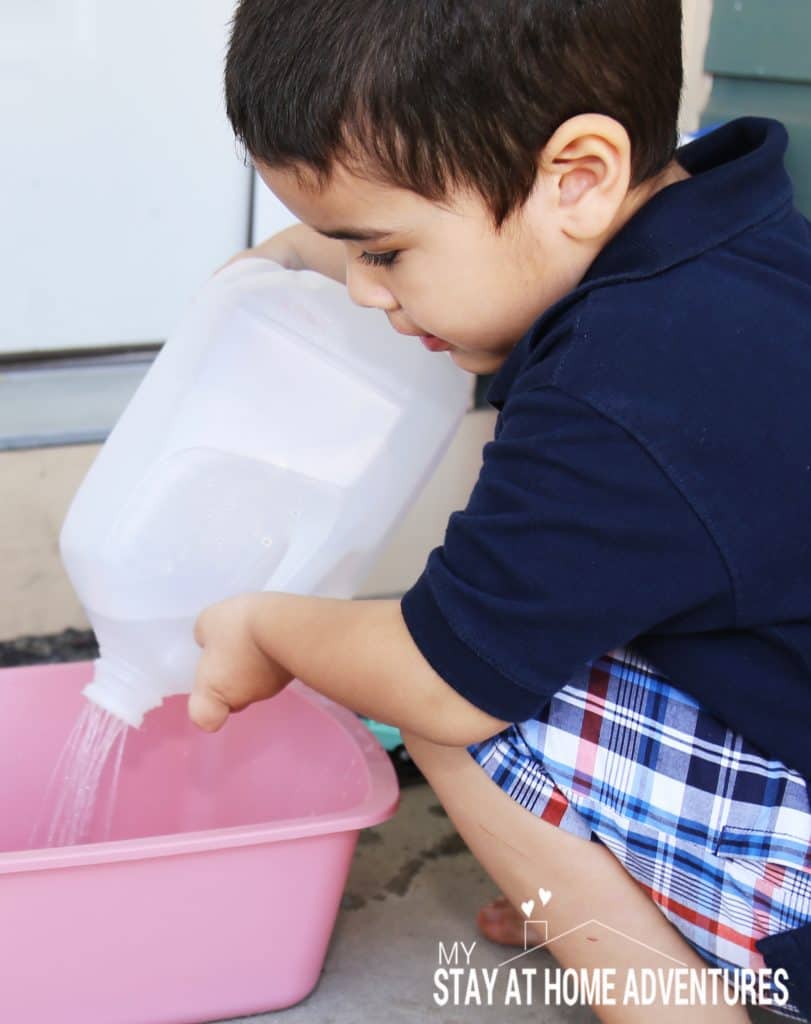 Little boy playing with diy watering can