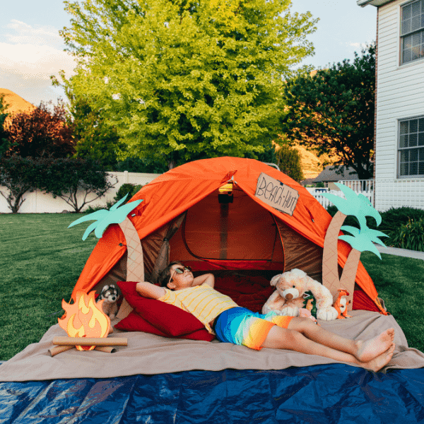 young man camping out in the backyard.