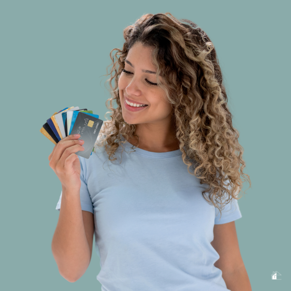 women holding credit cards in her hand and smiling.