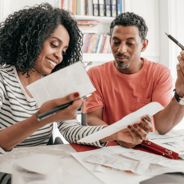 Couple in the kitchen with reciepts and laptop.