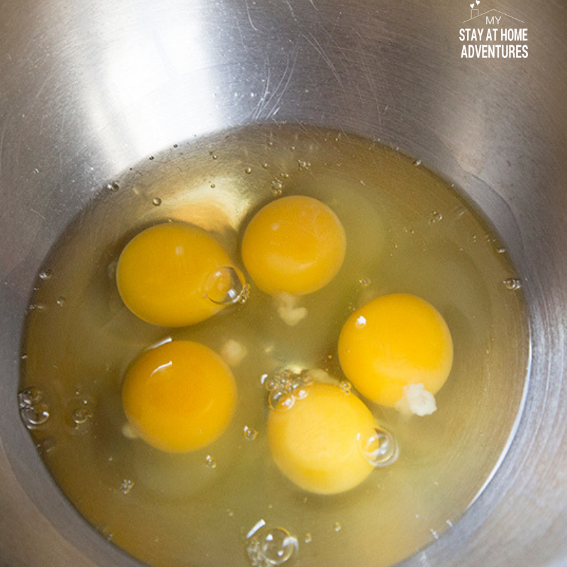 Use 5 small legs or 4 large to create a 2 ingredient Nutella cake. Add them to a bowl to begin to mix.