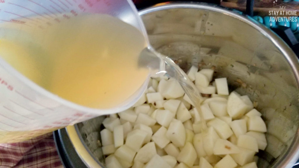 Add chicken broth and potatoes to the Instant Pot to make potato soup.