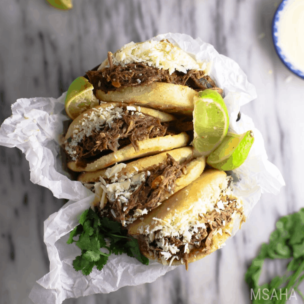 Arepas filled with cheese and carne mechada