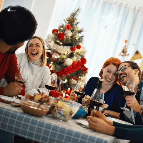 Group of friends sitting at the dinner table having fun during Christmas times