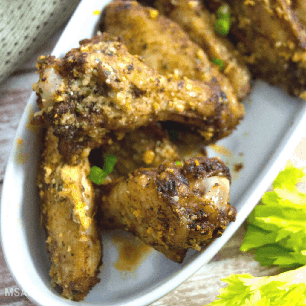 Plated chicken wings in white plate.