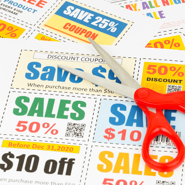 printables with coupons and a scissor on laying top.