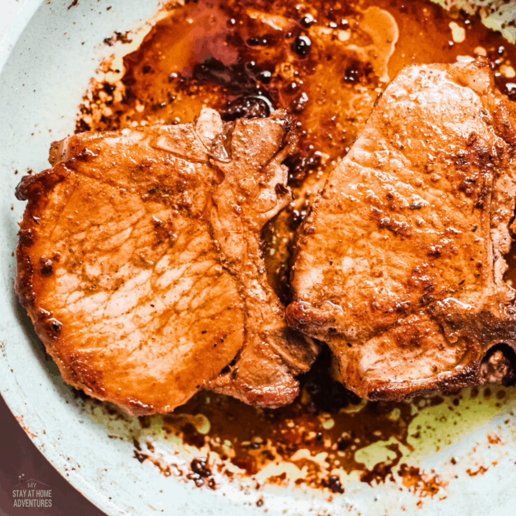 photo of two puerto rican pork chops in pan.