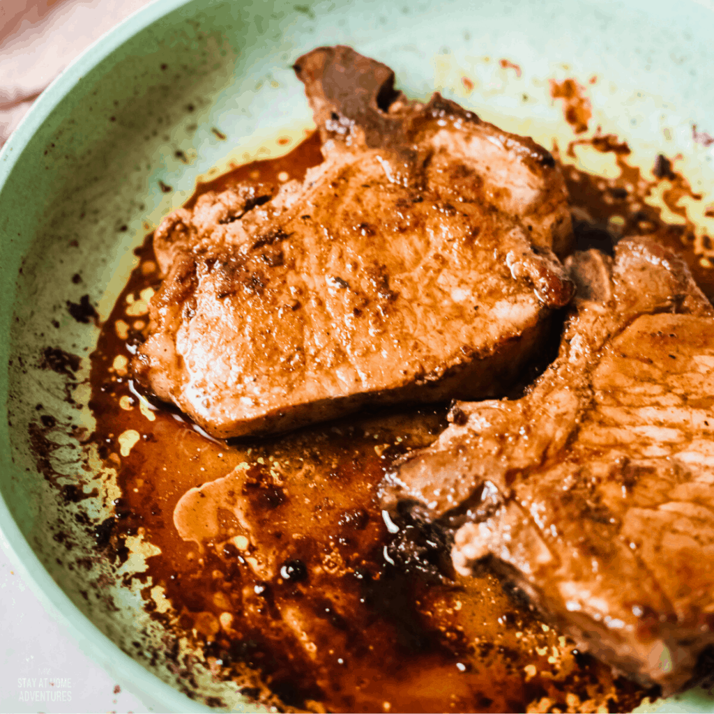 close up photo of pork chops in frying pan