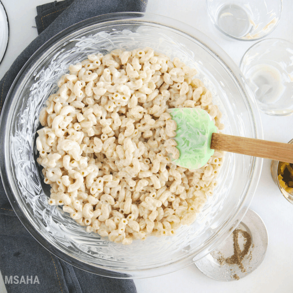 photo of macaroni with mayo in glass mixing bowl.