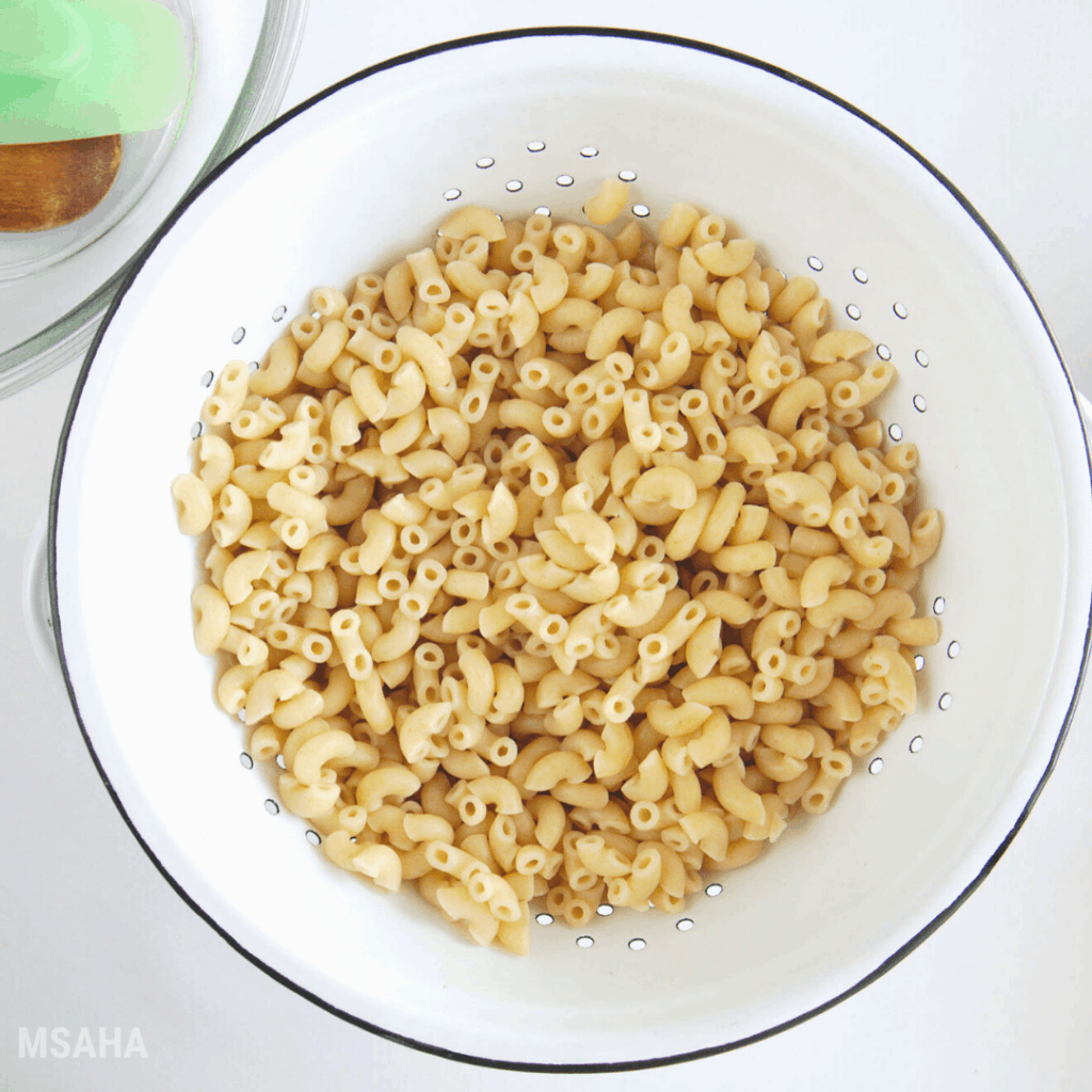 photo of cooked macaroni in a colander 