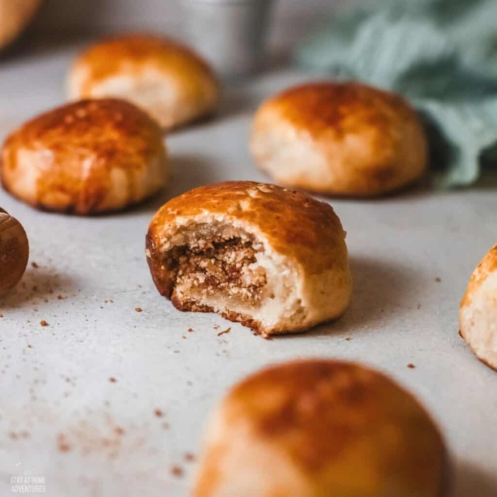 pan de coco rolls with center one bitten showing the coconut filling.