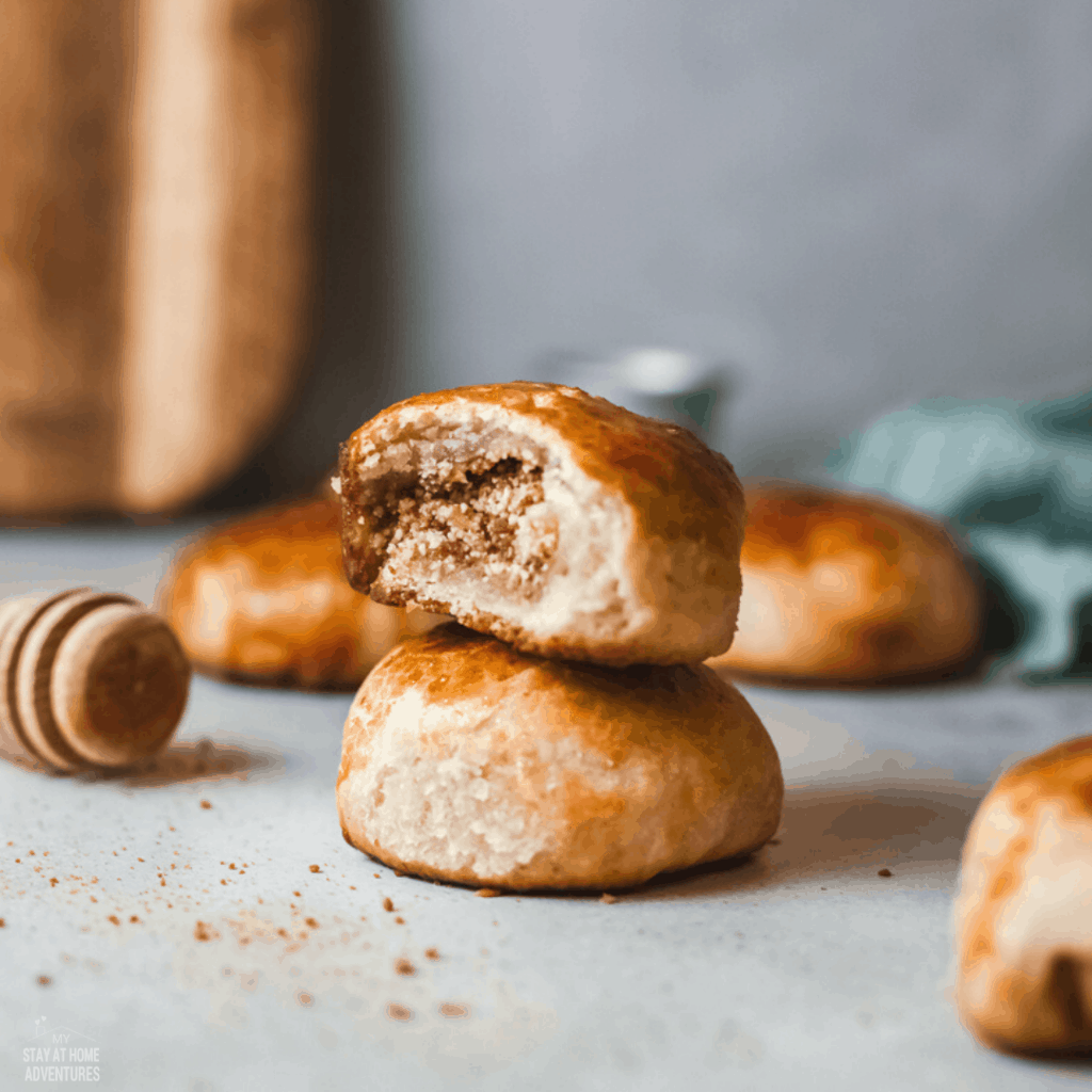 pan de coco rolls stacked with top one bitten to show filling.