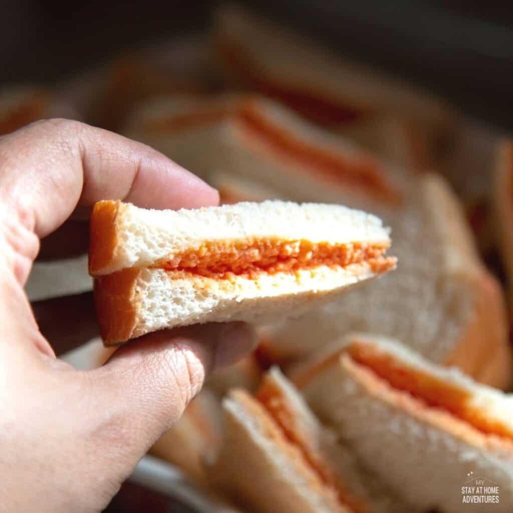Photo of sandwichitos being held with on hand.