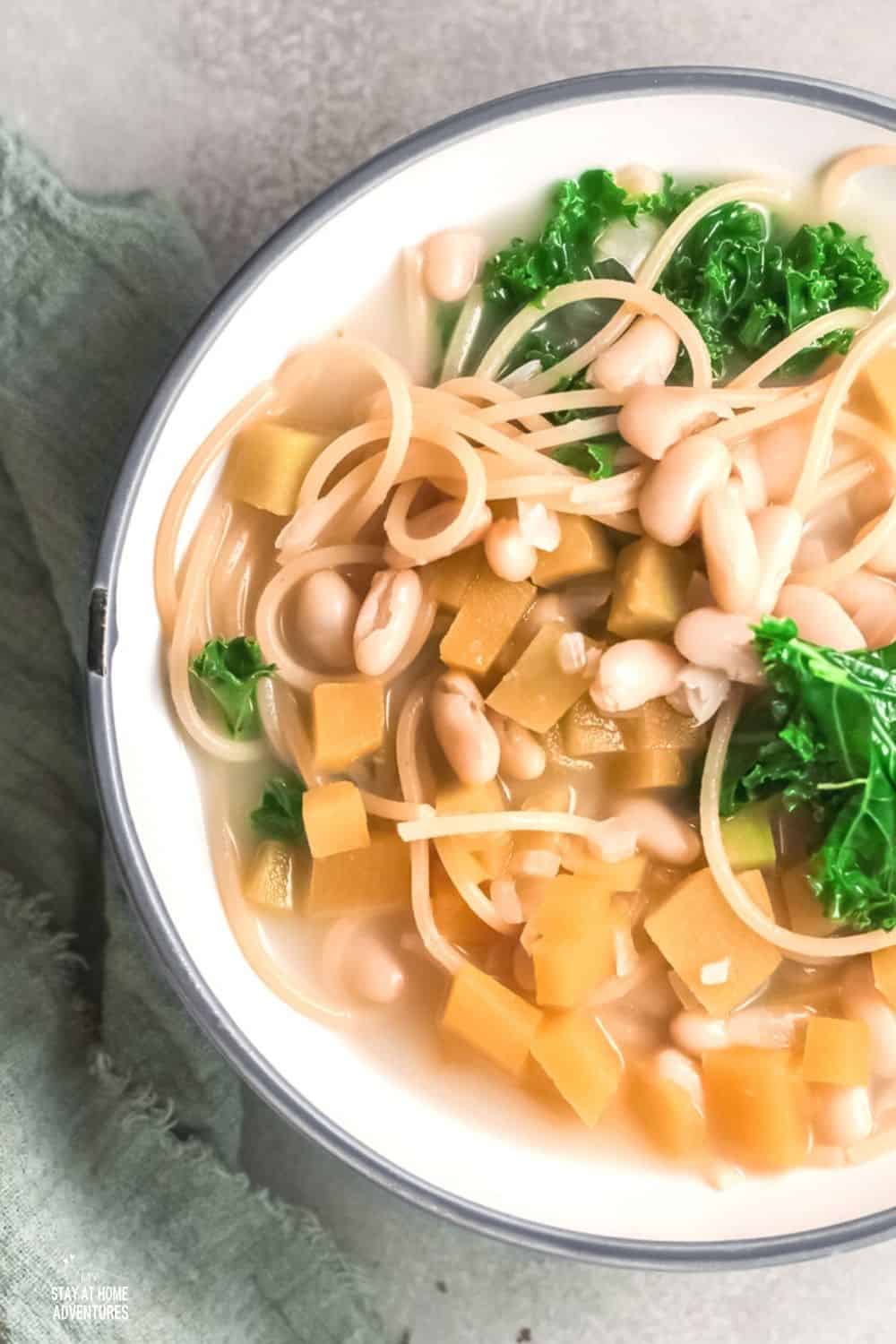 Porotos con rienda is a soup/stew made of boiled beans, spaghetti, pumpkin, onion, and greens of some sort. #soup #Chileanrecipe #beansoup #meatlesssoup via @mystayathome