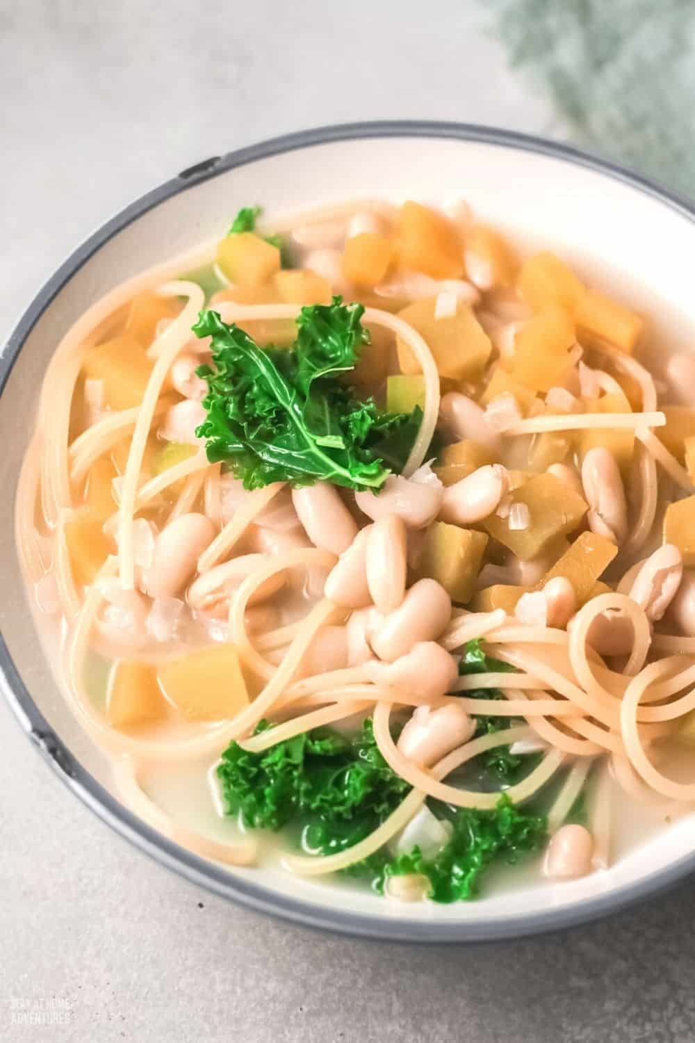 Porotos con rienda is a soup/stew made of boiled beans, spaghetti, pumpkin, onion, and greens of some sort. #soup #Chileanrecipe #beansoup #meatlesssoup via @mystayathome