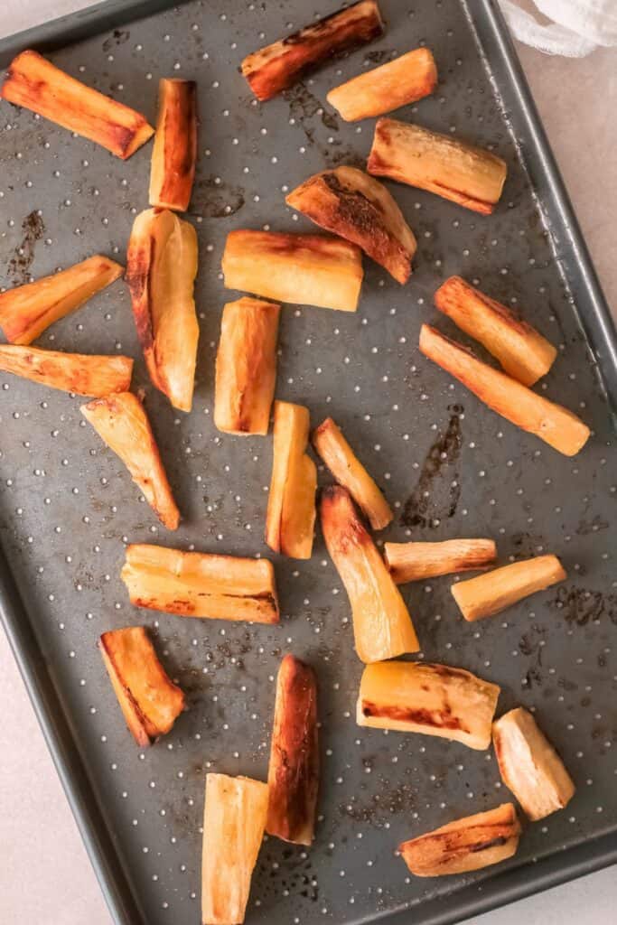 Baked cassava (yuca) fries in bake sheet.