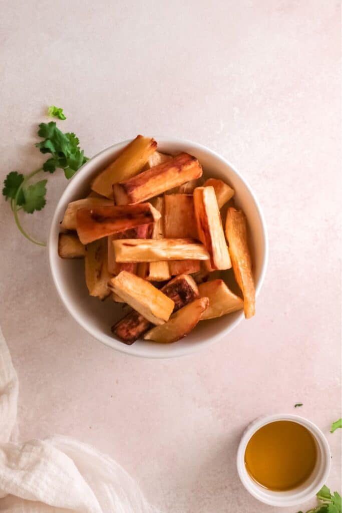 Top view of cassava fries seved with dip on the side.