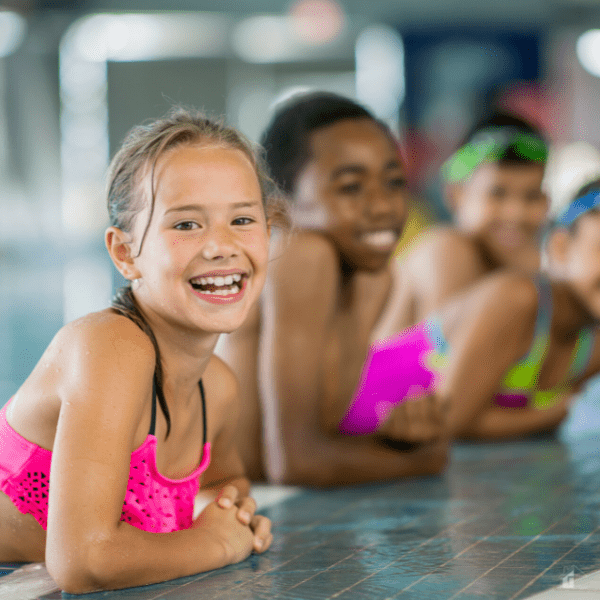Kids swimming at the local pool.