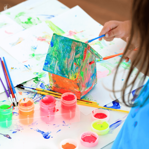 free summer activities for kids - kid painting a wooden house