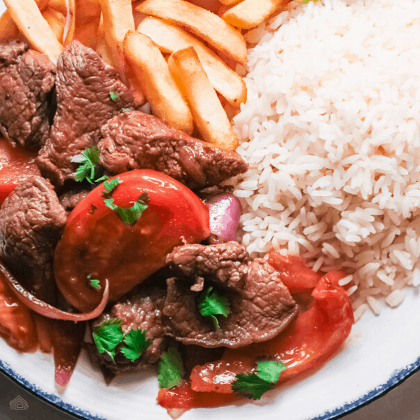 peruvian lomo saltado ina white plate