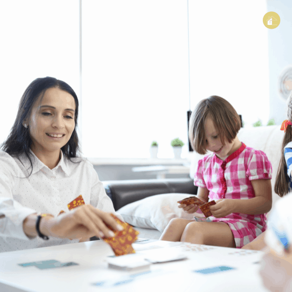 children playing board game with mom