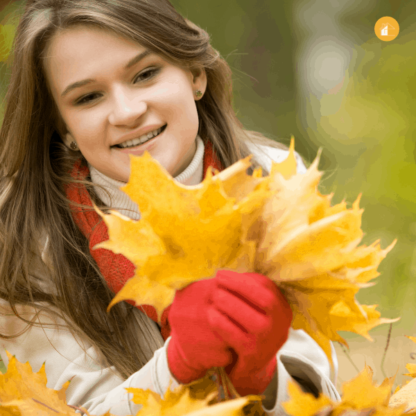 girl holding fall leaves