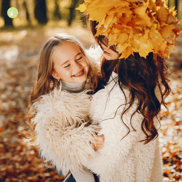 mom and daughter outside in the fall