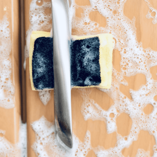 soapy cabinet with wet soapy sponge between handle and cabinet.