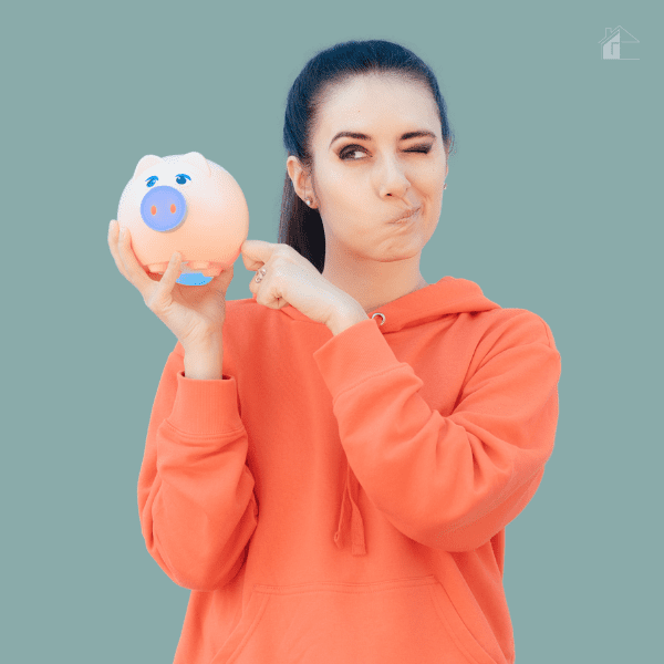 Young woman holding a piggy bank.