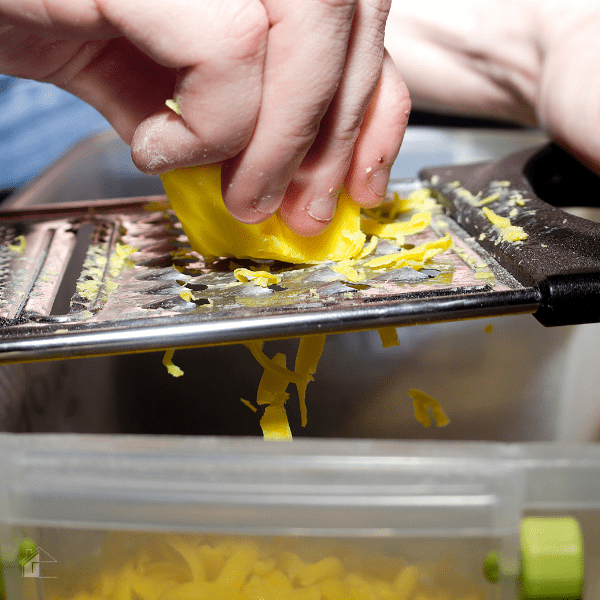 Man grinding a bar of soap to make his own laundry detergent.