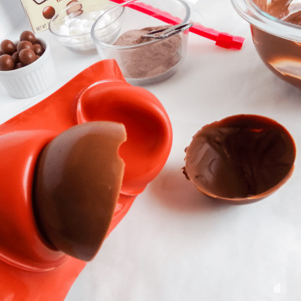 Removing chocolate from mold.