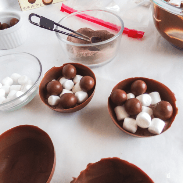 Filled chocolate bomb with marshmallows, whoppers, and crushed malted milk.