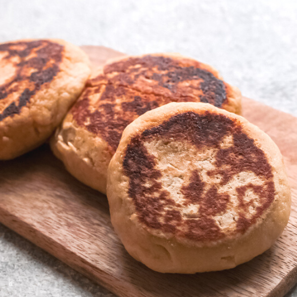 three gorditas de nata on top of a cutting board.