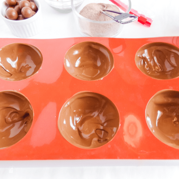 Melted chocolate in red mold.