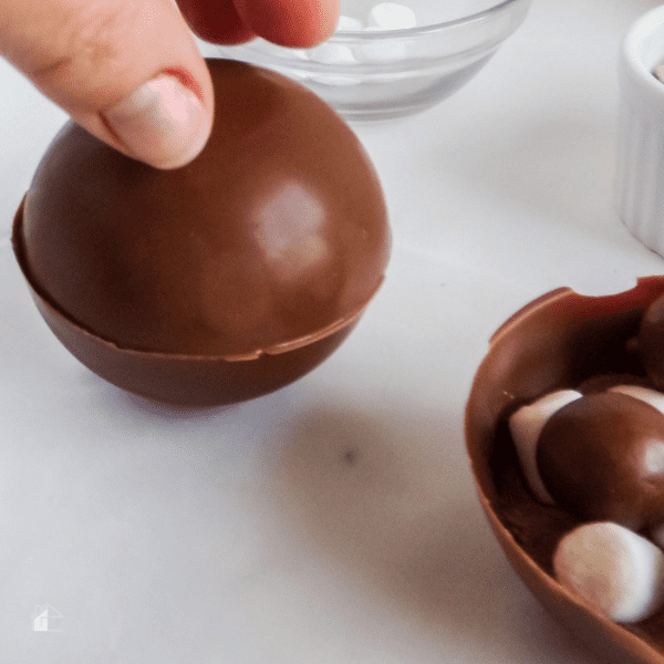 Pressing the chocolate bombs together.