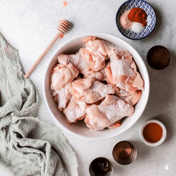 ingredients to make Bourbon Honey Air Fryer Chicken Wings Recipe - chicken wings, paprika, garlic powder, onion powder, salt bbq salt, apple cider vinegar, bourbon, brown sugar, honey.