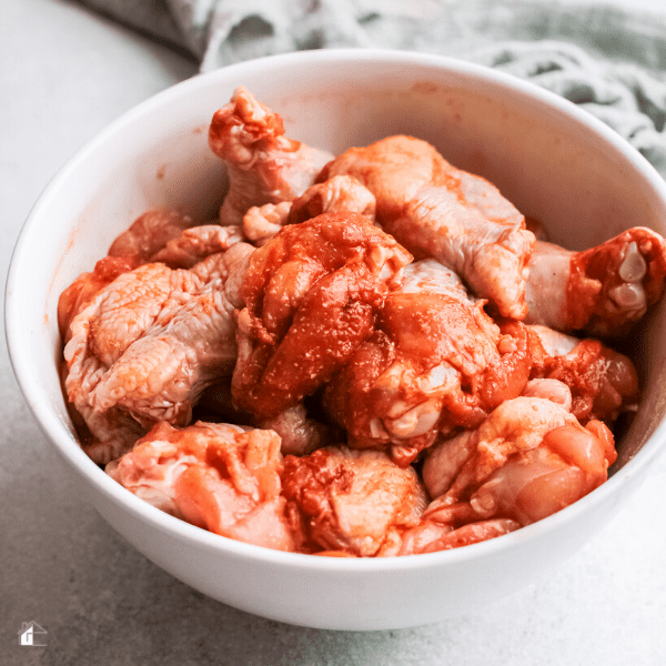 white bowl full of seasoned chicken wings