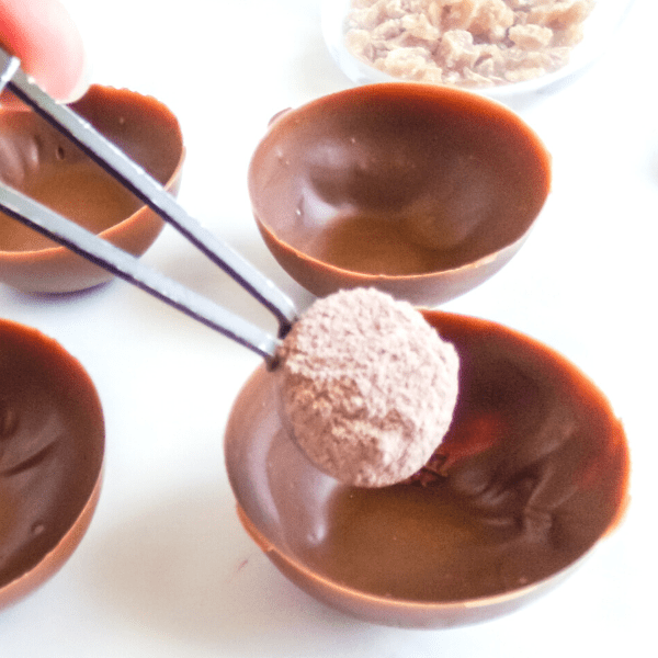 Filling chocolate cup with powder chocolate powder
