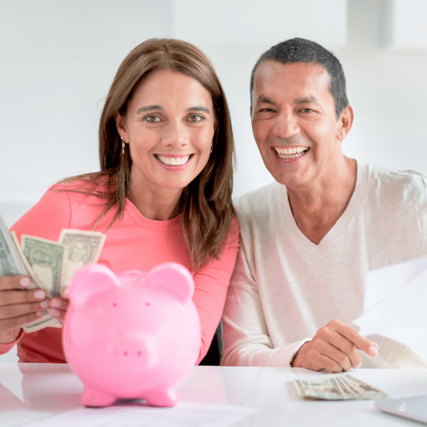 Happy couple saving money.