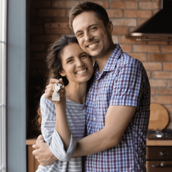 Happy couple holding house keys.
